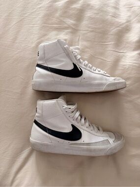 Nike Women's High-Top Sneakers in White with Black Swoosh and Orange Accent